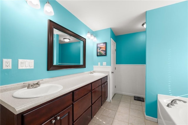 bathroom featuring vanity, tile patterned floors, and a bathtub