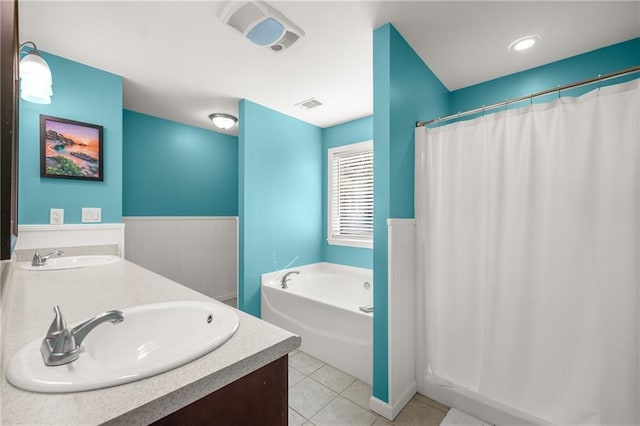 bathroom with tile patterned flooring, vanity, and a bathing tub