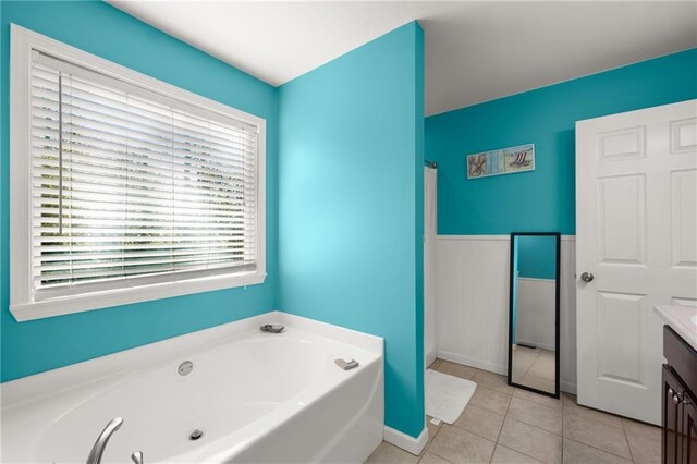 bathroom with a bath, tile patterned floors, and vanity