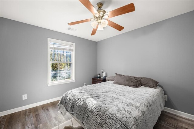 bedroom featuring ceiling fan and dark hardwood / wood-style flooring