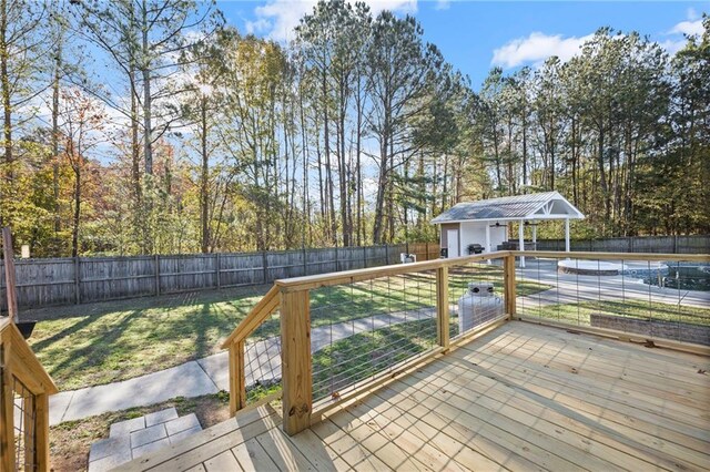 wooden deck with a swimming pool, a lawn, and an outdoor structure