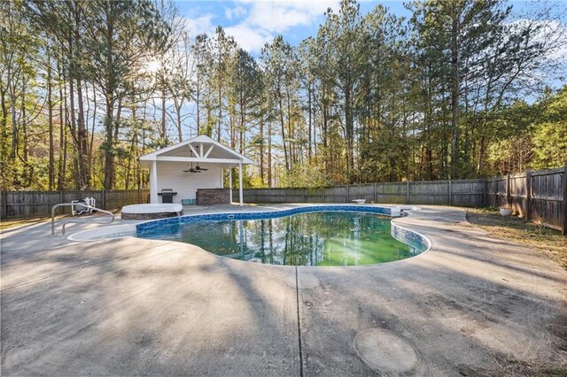 view of pool featuring ceiling fan and a patio