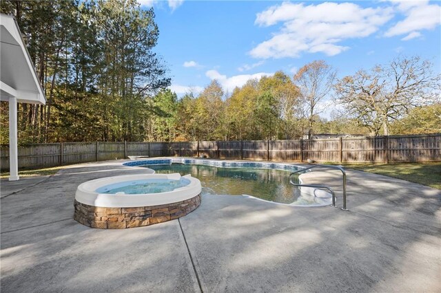 view of swimming pool with a patio area and an in ground hot tub