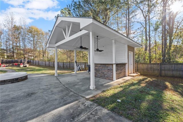 exterior space with a yard and ceiling fan