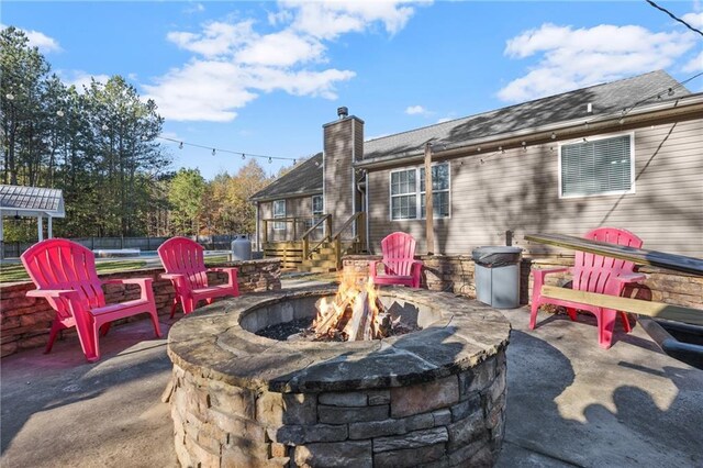 view of patio / terrace featuring an outdoor fire pit