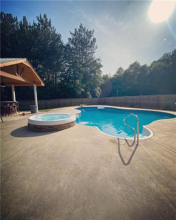 view of pool featuring an in ground hot tub and a patio