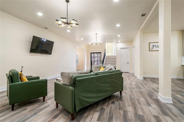 living room with hardwood / wood-style floors and a chandelier