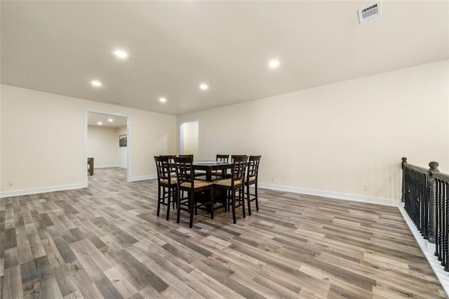 dining space with wood-type flooring