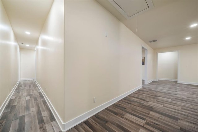 hallway with dark hardwood / wood-style flooring