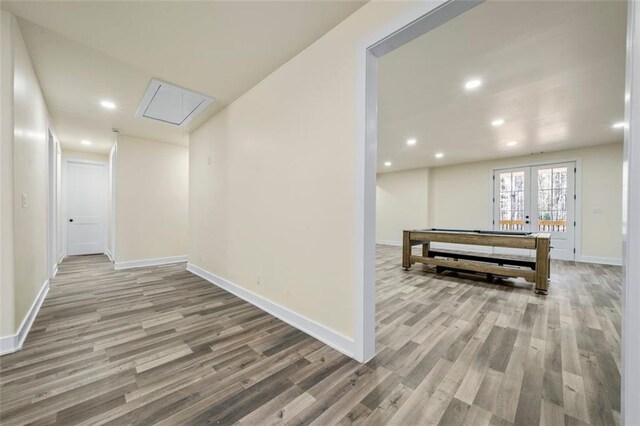 hall with french doors and wood-type flooring