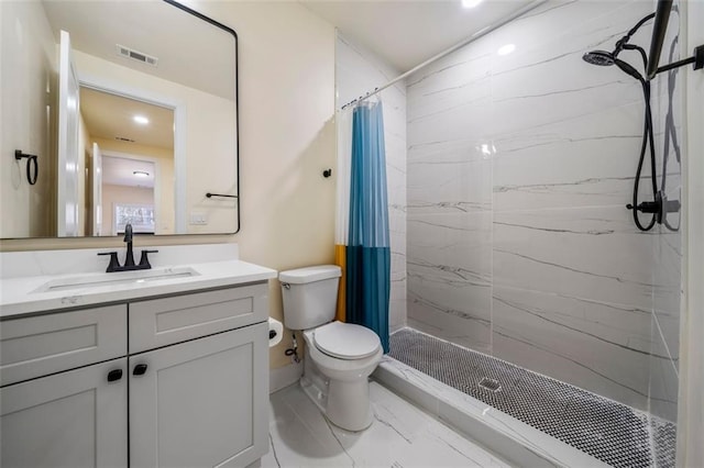 bathroom with vanity, toilet, and walk in shower