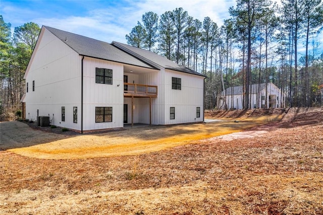 back of house featuring central AC and a balcony