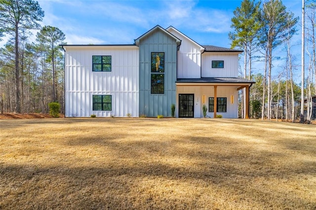 modern farmhouse style home with a front yard and a porch