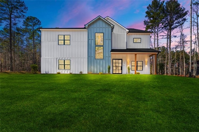 modern inspired farmhouse featuring a lawn