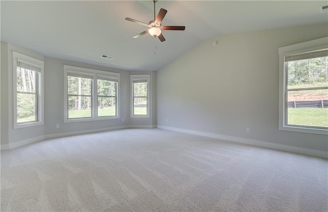 carpeted empty room with ceiling fan and vaulted ceiling