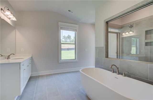 bathroom featuring lofted ceiling, tile patterned floors, separate shower and tub, and vanity