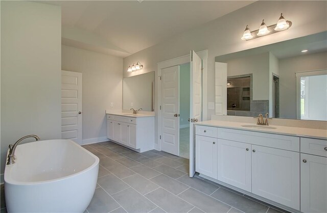 bathroom with vaulted ceiling, independent shower and bath, tile patterned flooring, and vanity