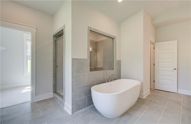 bathroom featuring separate shower and tub and tile patterned flooring