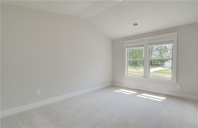 unfurnished room featuring lofted ceiling and carpet floors