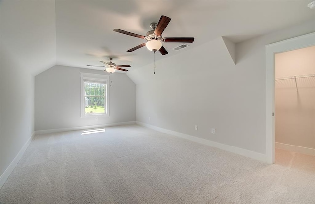 bonus room with lofted ceiling, ceiling fan, and light carpet