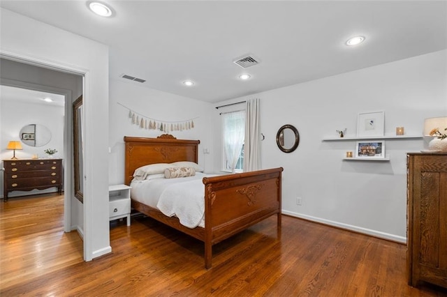 bedroom with wood finished floors, baseboards, and recessed lighting