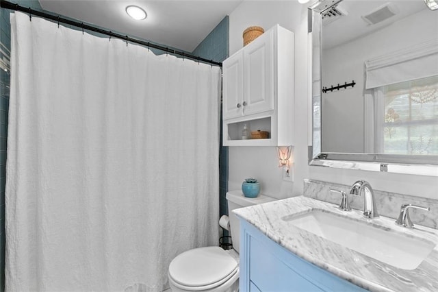 full bathroom with toilet and vanity