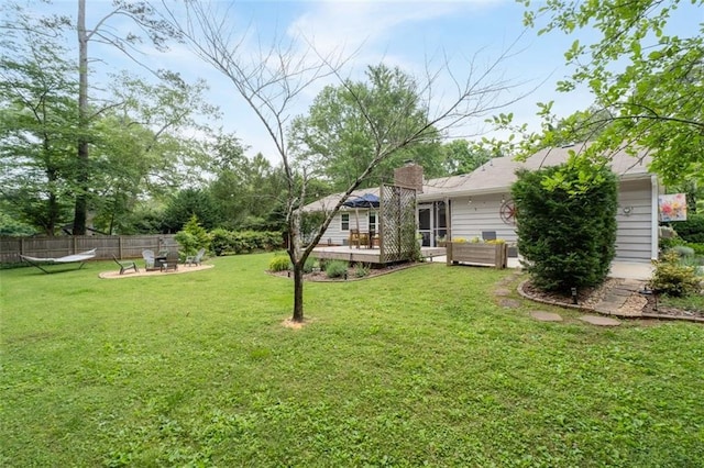 view of yard with a wooden deck and an outdoor living space with a fire pit