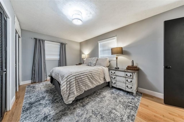 bedroom with a textured ceiling and hardwood / wood-style flooring