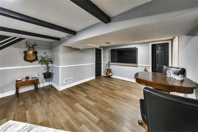 living room with wood-type flooring and beamed ceiling