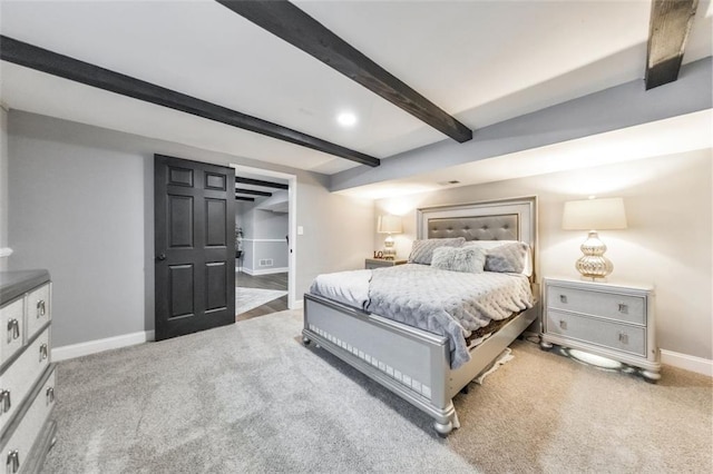 bedroom featuring carpet floors and beamed ceiling