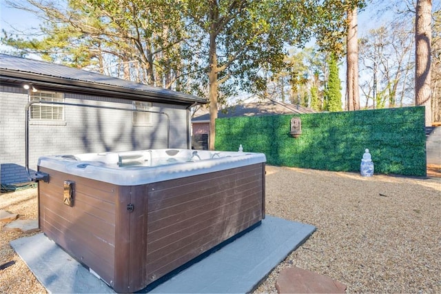 exterior space with a hot tub