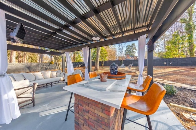 view of patio / terrace featuring an outdoor hangout area and a bar