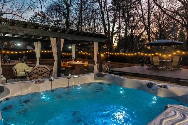 pool at dusk with a pergola and a patio area