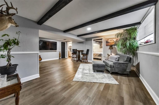 living room featuring dark hardwood / wood-style flooring and beamed ceiling