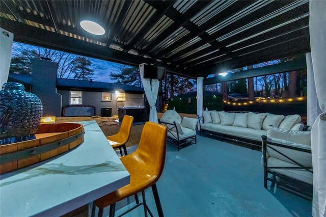 view of patio / terrace with an outdoor hangout area and a hot tub