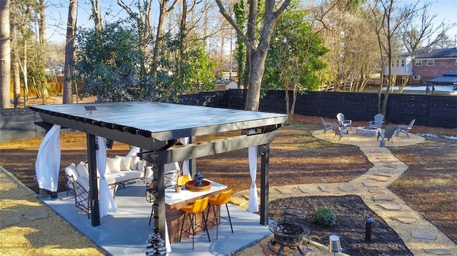 view of patio featuring an outdoor living space with a fire pit and a bar