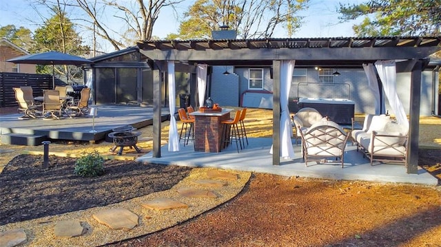 exterior space featuring a pergola, a sunroom, and a fire pit