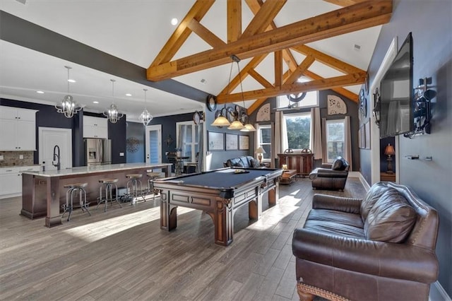 game room featuring sink, beamed ceiling, hardwood / wood-style flooring, high vaulted ceiling, and billiards