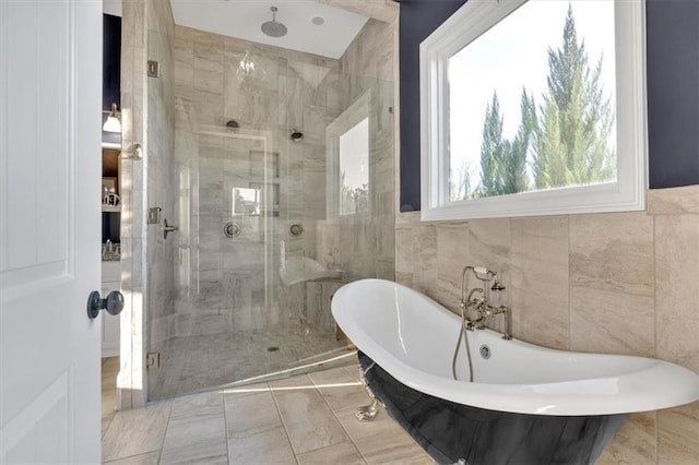 bathroom featuring tile walls and shower with separate bathtub