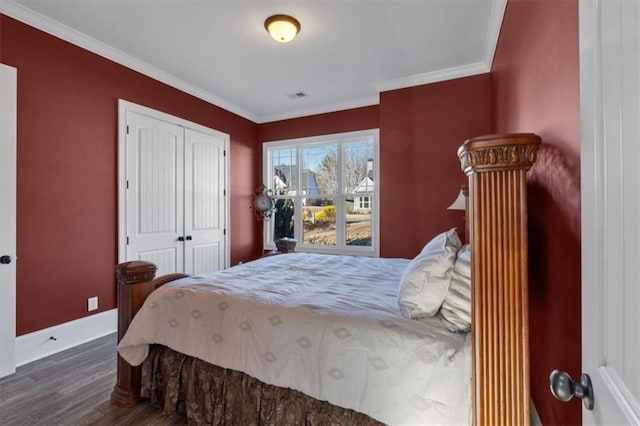 bedroom featuring a closet, crown molding, and dark hardwood / wood-style floors