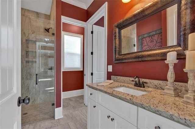 bathroom featuring a shower with door and vanity