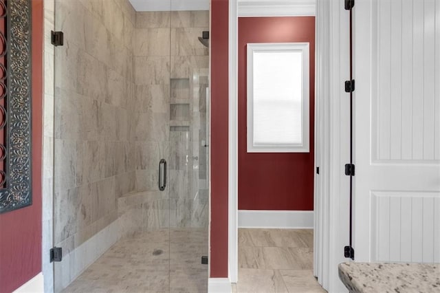 bathroom with a shower with door