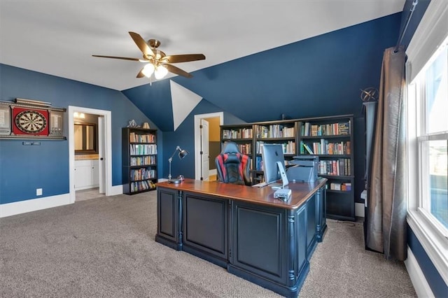 office space with vaulted ceiling, ceiling fan, and light colored carpet