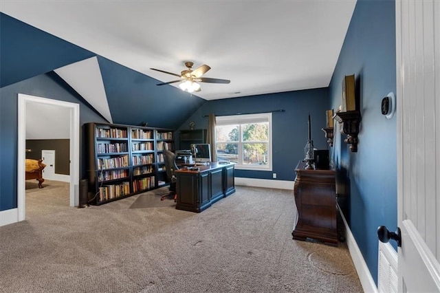 home office featuring vaulted ceiling, ceiling fan, and carpet flooring