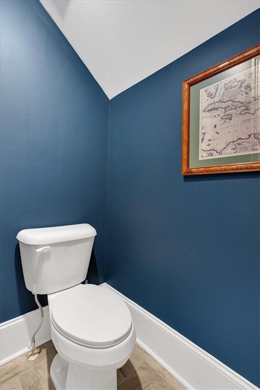 bathroom with vaulted ceiling and toilet