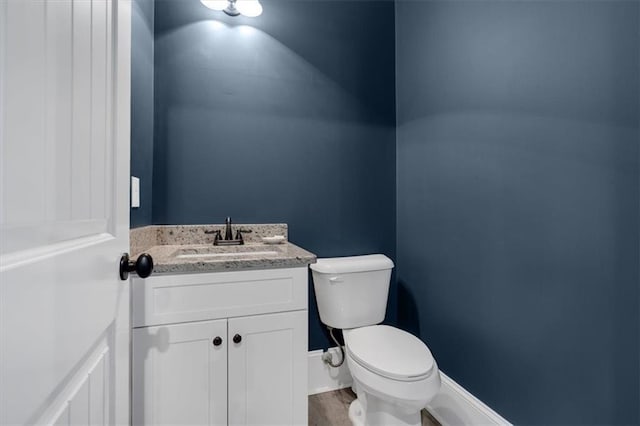 bathroom featuring toilet and vanity