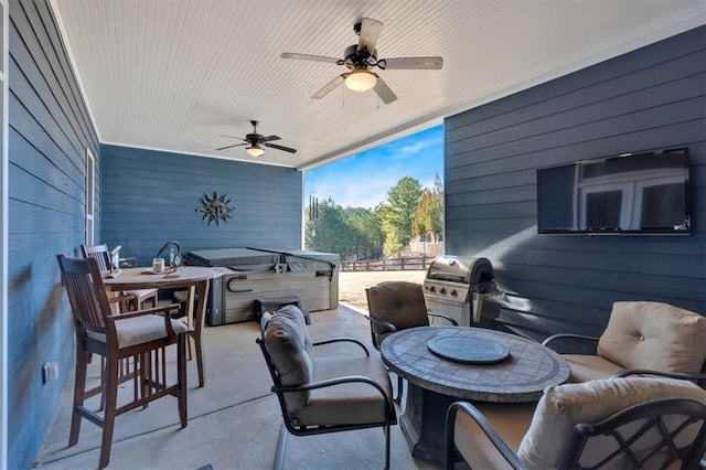 view of patio / terrace featuring ceiling fan, a grill, and a hot tub