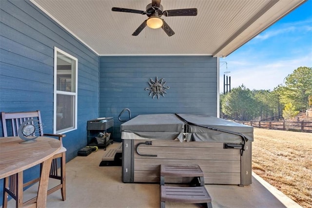 view of patio / terrace with ceiling fan and a hot tub