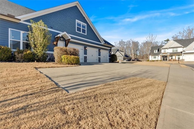 view of side of home with a yard and a garage