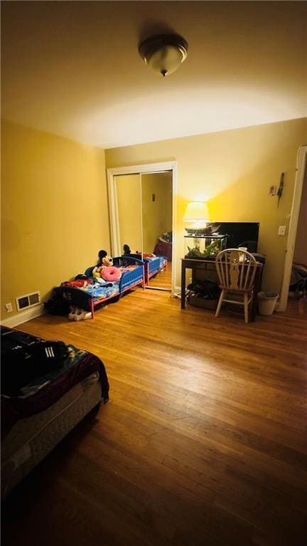 bedroom with hardwood / wood-style flooring and a closet